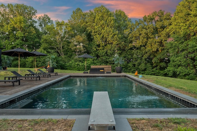 3360 Sweeney Hollow Rd, Franklin, TN 37064 - pool at dusk featuring a diving board, an outdoor pool, and a lawn