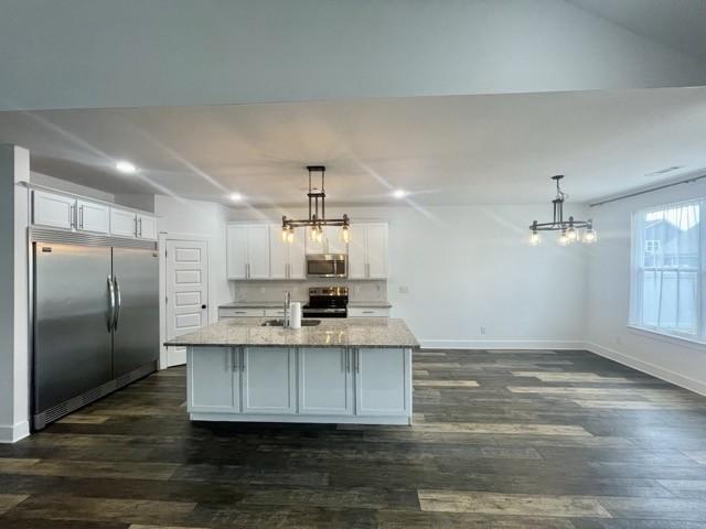 2412 Bullrush Ln, Murfreesboro, TN 37128 - kitchen featuring a chandelier, stainless steel appliances, an island with sink, white cabinets, and light stone countertops