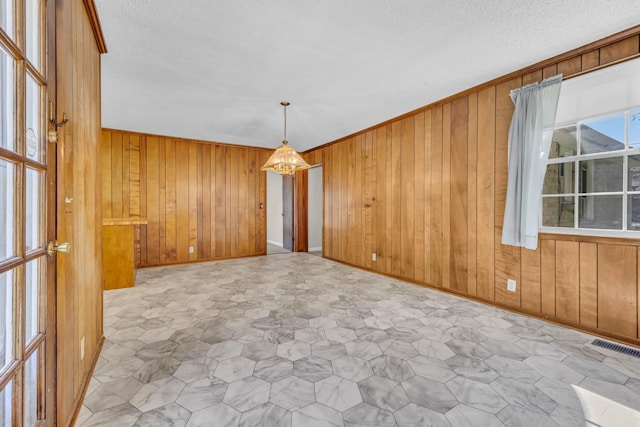 207 Short St, Clarksville, TN 37042 - empty room featuring wood walls, a textured ceiling, and crown molding