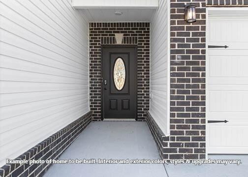 918 Vendue Ave, Clarksville, TN 37042 - doorway to property with brick siding and a garage