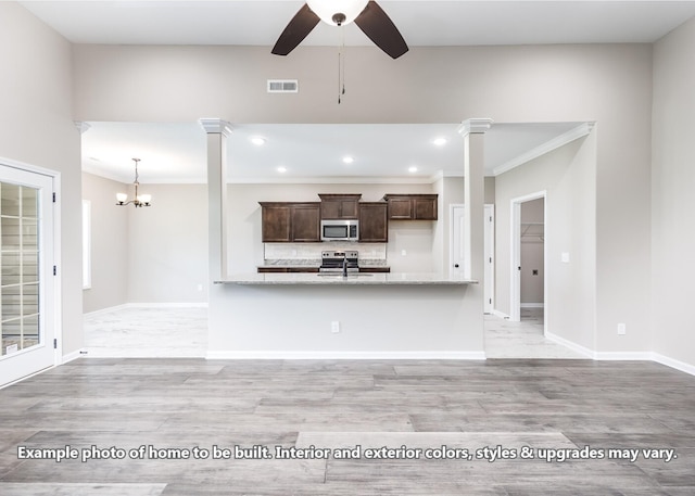914 Vendue Ave, Clarksville, TN 37042 - kitchen with stainless steel microwave, dark brown cabinets, recessed lighting, backsplash, and a ceiling fan