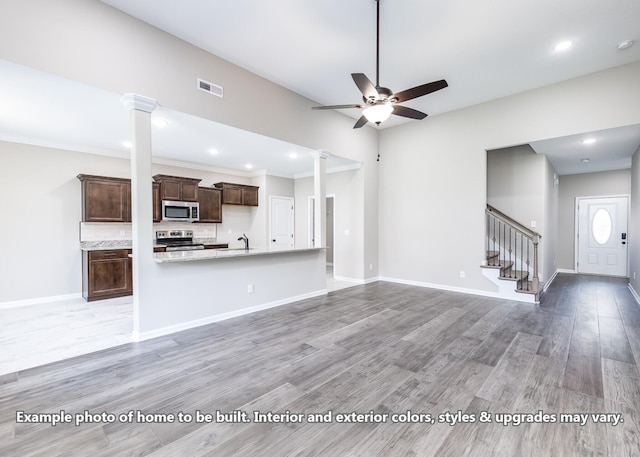 914 Vendue Ave, Clarksville, TN 37042 - unfurnished living room featuring ornate columns, a ceiling fan, stairs, light wood-style floors, and recessed lighting