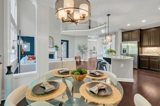 412 Warren Hill Dr, Mount Juliet, TN 37122 - dining area featuring a chandelier, a high ceiling, dark wood finished floors, recessed lighting, and ornate columns