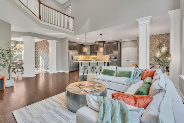412 Warren Hill Dr, Mount Juliet, TN 37122 - living room featuring ornate columns, a towering ceiling, dark wood-style flooring, and recessed lighting