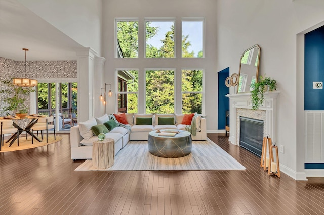 412 Warren Hill Dr, Mount Juliet, TN 37122 - living room featuring a towering ceiling, plenty of natural light, hardwood / wood-style floors, a glass covered fireplace, and a chandelier