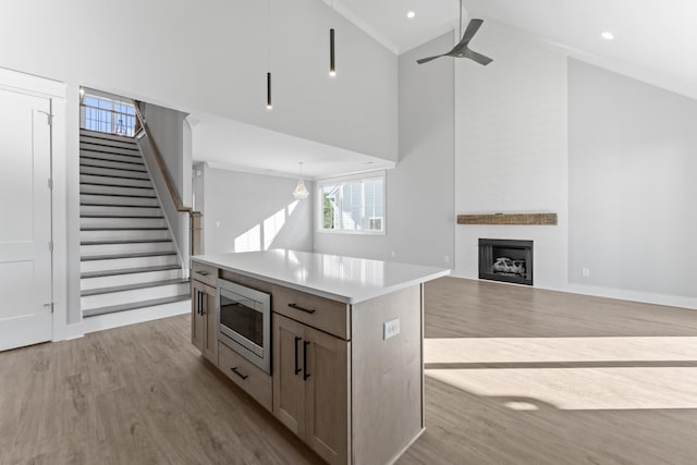 316 Campfire Ct, Winchester, TN 37398 - kitchen with stainless steel microwave, high vaulted ceiling, wood finished floors, ceiling fan, and a kitchen island