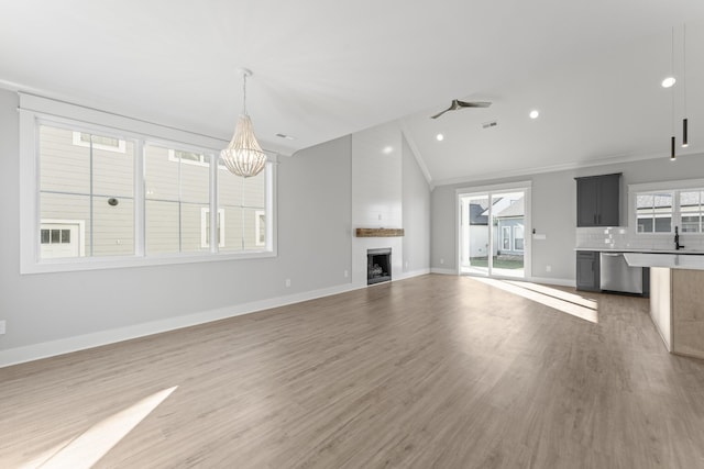 316 Campfire Ct, Winchester, TN 37398 - unfurnished living room with lofted ceiling, light wood-style floors, a chandelier, a fireplace, and recessed lighting