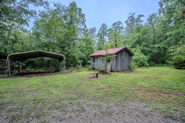 366 Ridge Rd, Westpoint, TN 38486 - view of green lawn featuring an outbuilding, a detached carport, and a forest view