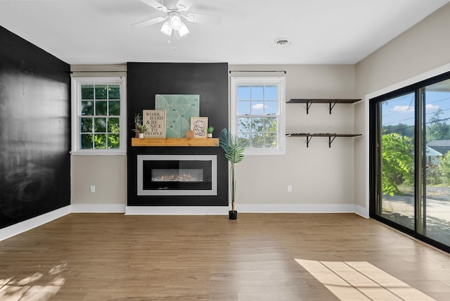 1872 River Rd, Clarksville, TN 37040 - unfurnished living room with a glass covered fireplace, wood finished floors, and ceiling fan