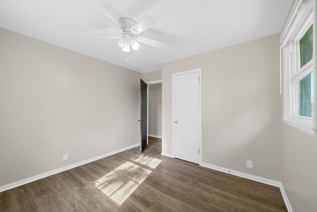1872 River Rd, Clarksville, TN 37040 - unfurnished bedroom with wood finished floors, multiple windows, and a ceiling fan