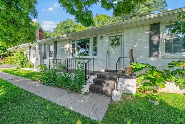 1872 River Rd, Clarksville, TN 37040 - view of front facade featuring brick siding, a chimney, and a front lawn