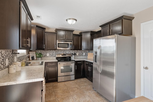 3754 Gray Fox Dr, Clarksville, TN 37040 - kitchen featuring appliances with stainless steel finishes, decorative backsplash, dark brown cabinetry, and light countertops