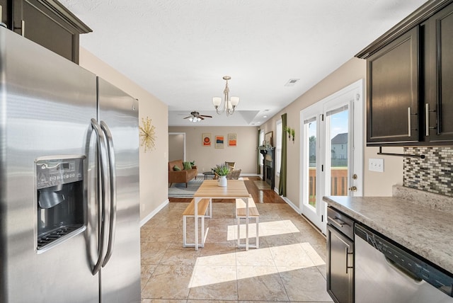 3754 Gray Fox Dr, Clarksville, TN 37040 - kitchen with appliances with stainless steel finishes, a chandelier, tasteful backsplash, decorative light fixtures, and light countertops