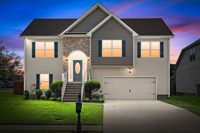 3754 Gray Fox Dr, Clarksville, TN 37040 - split foyer home featuring concrete driveway, a yard, a garage, and stone siding