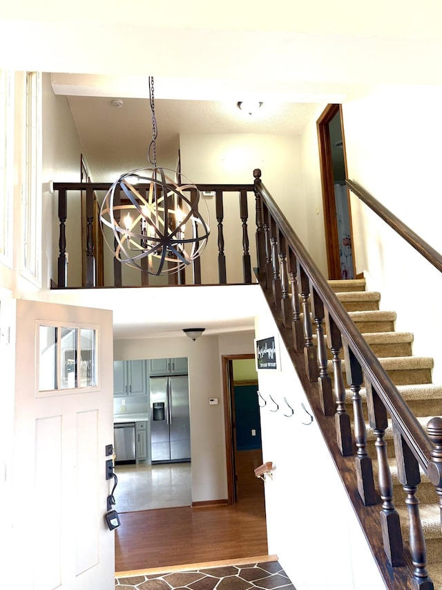 806 Sharon Cir, Lawrenceburg, TN 38464 - stairway featuring a chandelier, wood finished floors, and a high ceiling