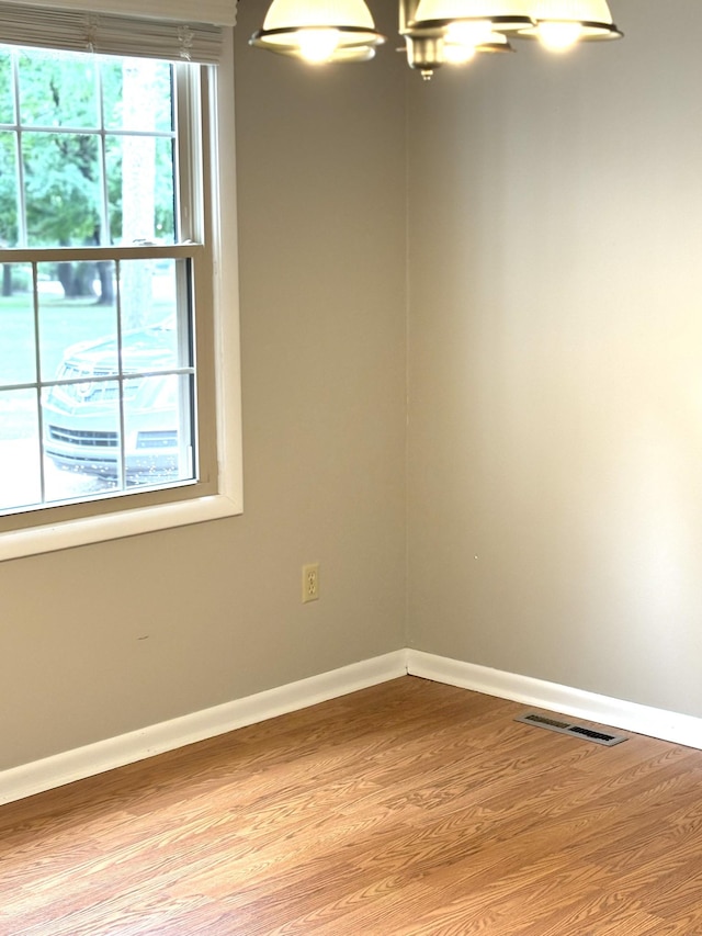 806 Sharon Cir, Lawrenceburg, TN 38464 - unfurnished room with wood finished floors and a chandelier