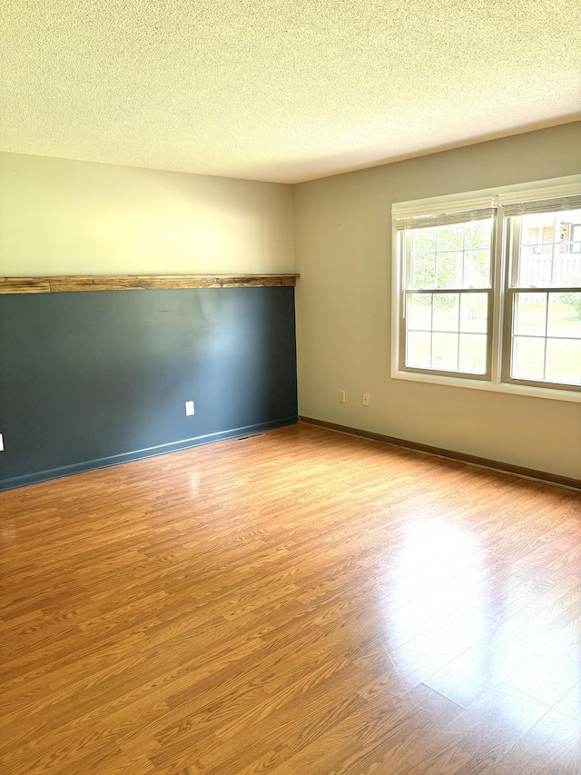 806 Sharon Cir, Lawrenceburg, TN 38464 - spare room with wood finished floors and a textured ceiling