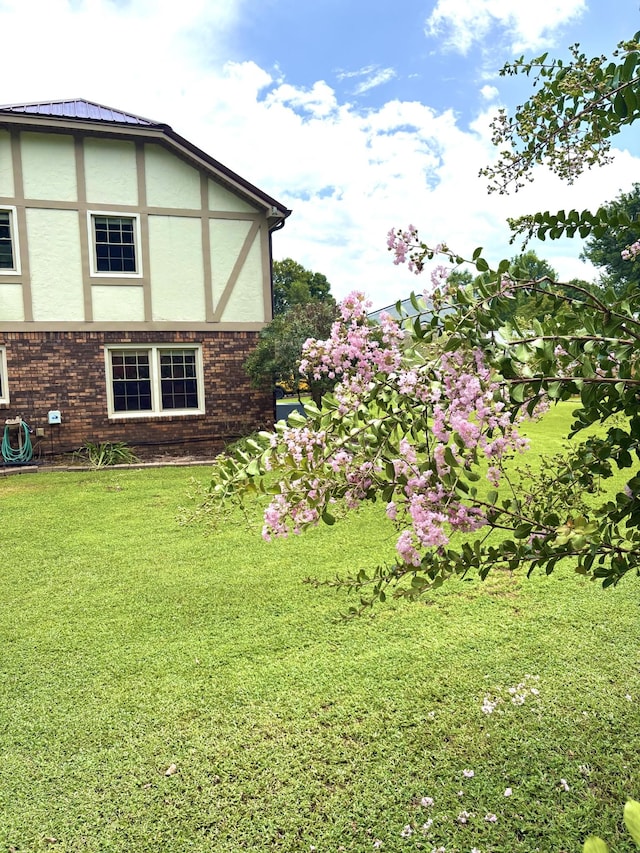 806 Sharon Cir, Lawrenceburg, TN 38464 - view of property exterior with stucco siding, a lawn, and brick siding