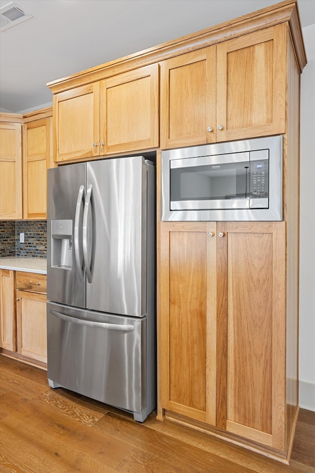 3200 Crockett Pointe, Jasper, TN 37347 - kitchen featuring stainless steel appliances, wood finished floors, backsplash, light countertops, and light brown cabinetry