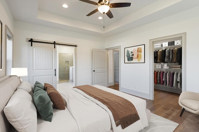 3200 Crockett Pointe, Jasper, TN 37347 - bedroom with a walk in closet, wood finished floors, a barn door, ensuite bathroom, and recessed lighting