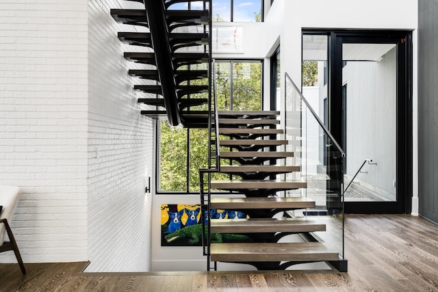 4606 Shys Hill Rd, Nashville, TN 37215 - staircase featuring wood finished floors and brick wall