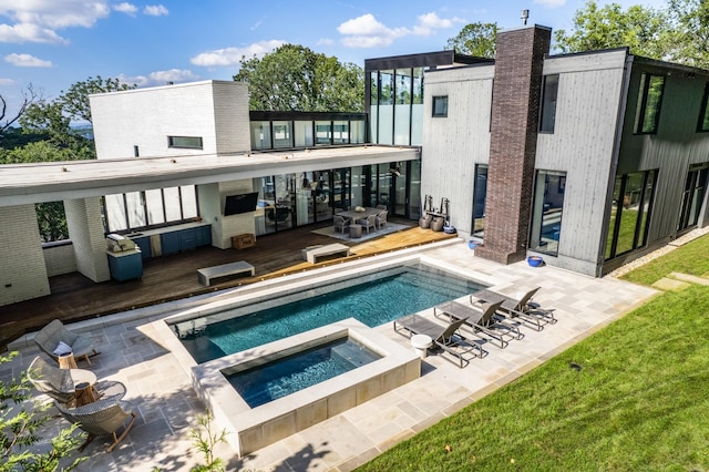 4606 Shys Hill Rd, Nashville, TN 37215 - rear view of property featuring a deck, an in-ground hot tub, an outdoor pool, and a patio area