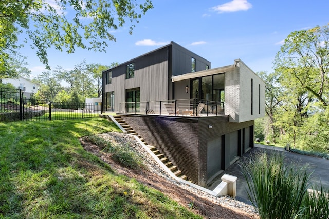 4606 Shys Hill Rd, Nashville, TN 37215 - back of house featuring an attached garage, stairs, and driveway