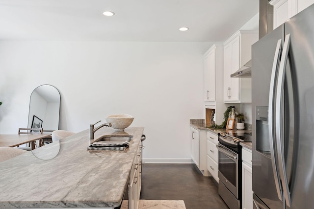4711 Compassion Ln, Murfreesboro, TN 37128 - kitchen featuring stainless steel appliances, concrete flooring, white cabinets, an island with sink, and recessed lighting