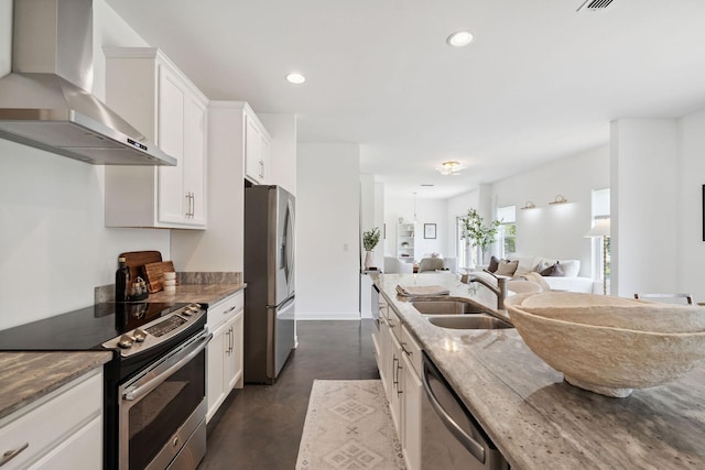 4711 Compassion Ln, Murfreesboro, TN 37128 - kitchen with wall chimney range hood, appliances with stainless steel finishes, open floor plan, finished concrete flooring, and light stone countertops
