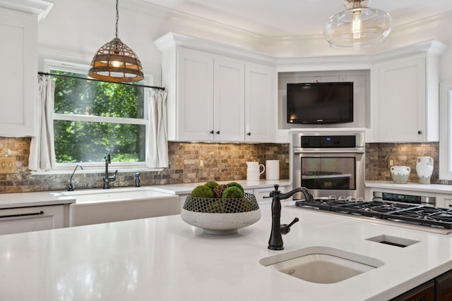 2000 Far Fara Way, Brentwood, TN 37027 - kitchen featuring appliances with stainless steel finishes, decorative light fixtures, white cabinetry, and ornamental molding