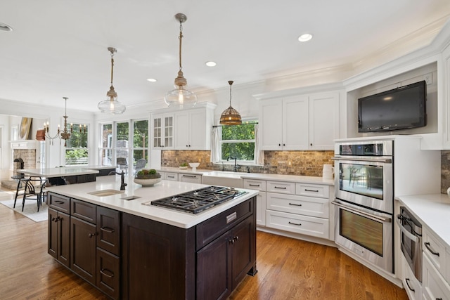 2000 Far Fara Way, Brentwood, TN 37027 - kitchen featuring appliances with stainless steel finishes, dark brown cabinets, white cabinets, light countertops, and tasteful backsplash