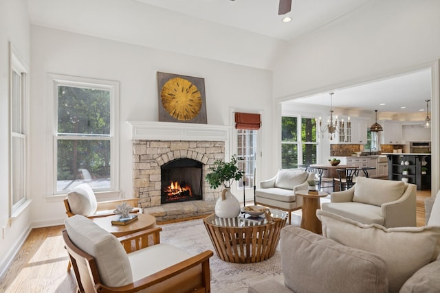 2000 Far Fara Way, Brentwood, TN 37027 - living area featuring a ceiling fan, a fireplace, light wood finished floors, a chandelier, and vaulted ceiling