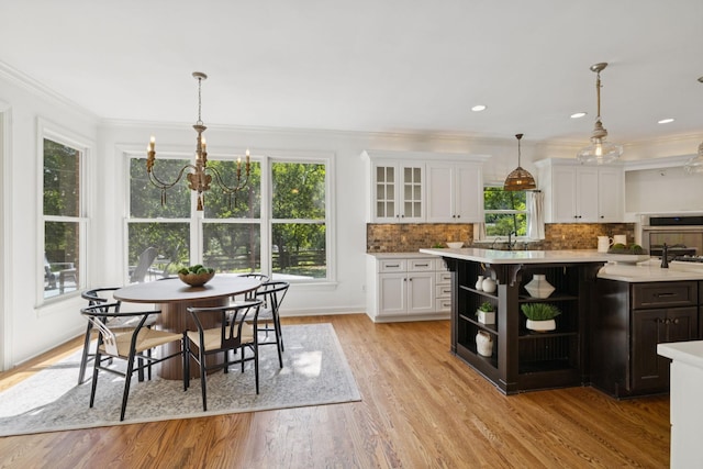 2000 Far Fara Way, Brentwood, TN 37027 - kitchen featuring white cabinetry, light countertops, decorative backsplash, light wood-style flooring, and crown molding