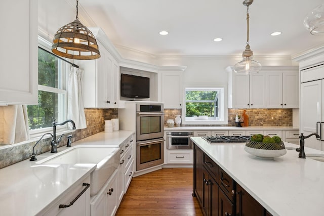 2000 Far Fara Way, Brentwood, TN 37027 - kitchen featuring appliances with stainless steel finishes, white cabinets, light countertops, pendant lighting, and dark brown cabinets
