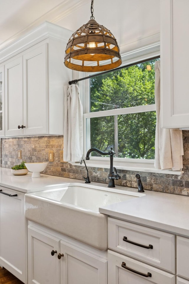 2000 Far Fara Way, Brentwood, TN 37027 - kitchen featuring decorative backsplash, white cabinets, light countertops, pendant lighting, and crown molding