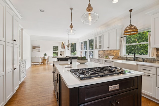 2000 Far Fara Way, Brentwood, TN 37027 - kitchen with light countertops, a kitchen island with sink, white cabinets, stainless steel gas stovetop, and backsplash