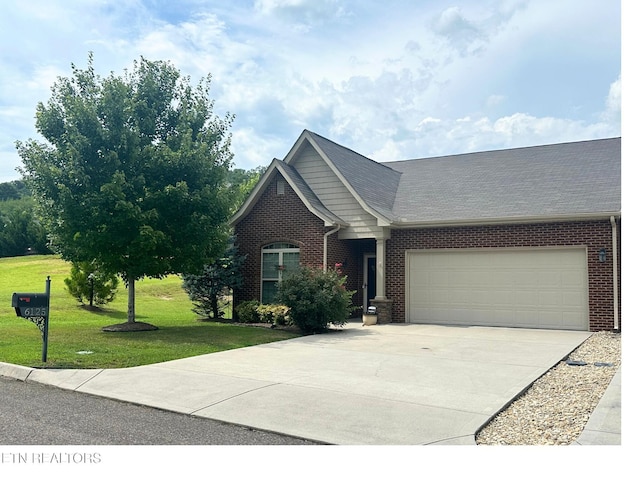 6125 Mcmillan Creek Dr, Knoxville, TN 37924 - view of front facade with brick siding, concrete driveway, an attached garage, and a front yard