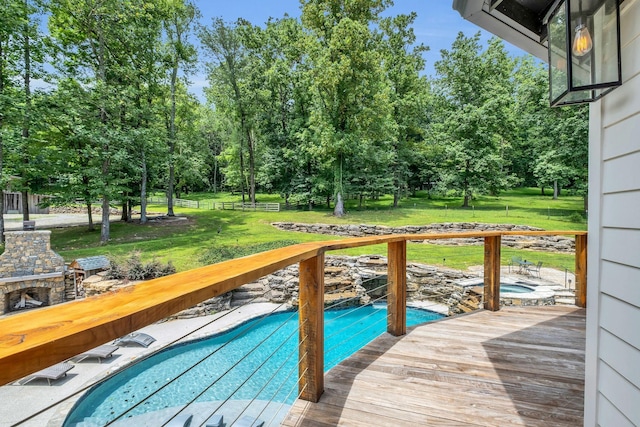 3120 Boxley View Ln, Franklin, TN 37064 - deck featuring an outdoor pool, view of wooded area, an outdoor stone fireplace, and a lawn