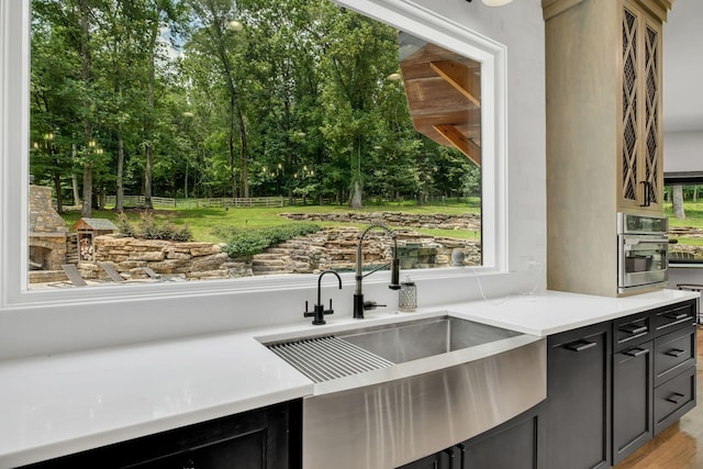 3120 Boxley View Ln, Franklin, TN 37064 - kitchen with stainless steel oven, light countertops, and dark cabinets