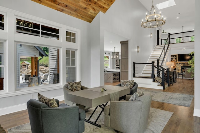 3120 Boxley View Ln, Franklin, TN 37064 - living area featuring a chandelier, stairway, a high ceiling, a fireplace, and wood finished floors