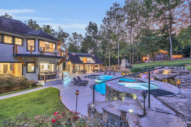 3120 Boxley View Ln, Franklin, TN 37064 - pool at dusk featuring an outdoor fire pit, a patio area, a lawn, and a pool with connected hot tub