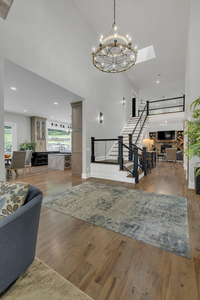 3120 Boxley View Ln, Franklin, TN 37064 - living room featuring stairs, light wood-style floors, a chandelier, recessed lighting, and a towering ceiling