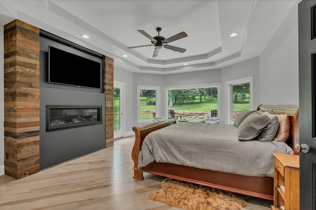 3120 Boxley View Ln, Franklin, TN 37064 - bedroom featuring a raised ceiling, light wood finished floors, a large fireplace, access to exterior, and recessed lighting