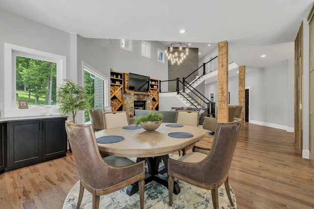 3120 Boxley View Ln, Franklin, TN 37064 - dining space featuring a fireplace, plenty of natural light, a chandelier, light wood-style flooring, and recessed lighting