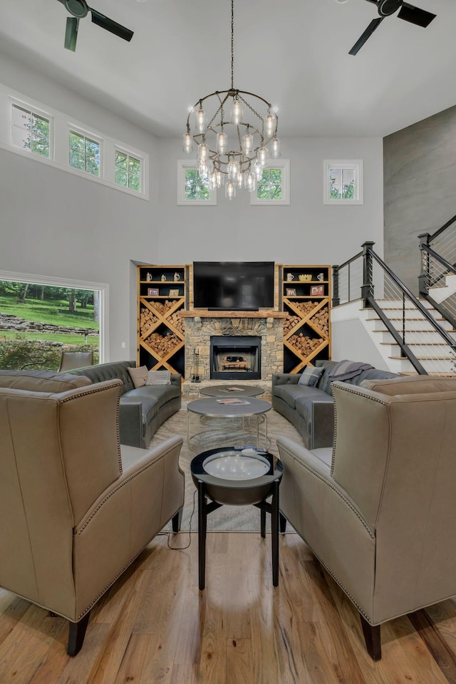 3120 Boxley View Ln, Franklin, TN 37064 - living room featuring a ceiling fan, a stone fireplace, and wood finished floors