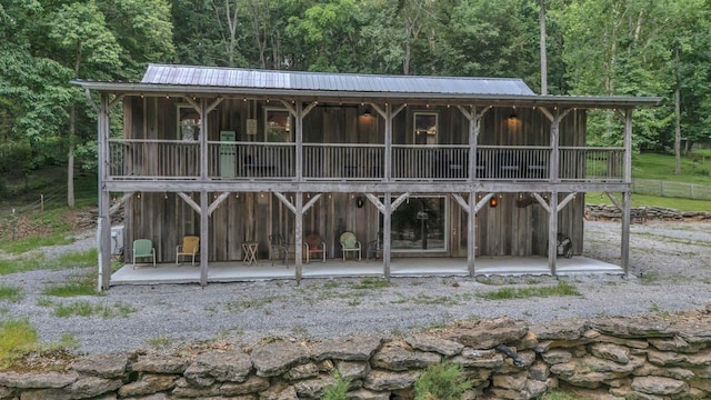 3120 Boxley View Ln, Franklin, TN 37064 - rear view of property with a wooded view, a patio, a metal roof, and board and batten siding
