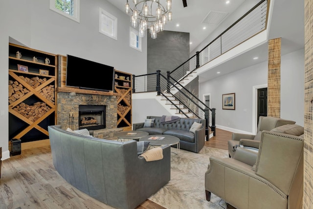 3120 Boxley View Ln, Franklin, TN 37064 - living area with a high ceiling, wood finished floors, a stone fireplace, stairway, and a chandelier