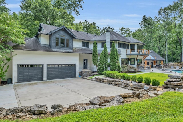 3120 Boxley View Ln, Franklin, TN 37064 - view of front facade with a balcony, driveway, an outdoor pool, a shingled roof, and a front yard