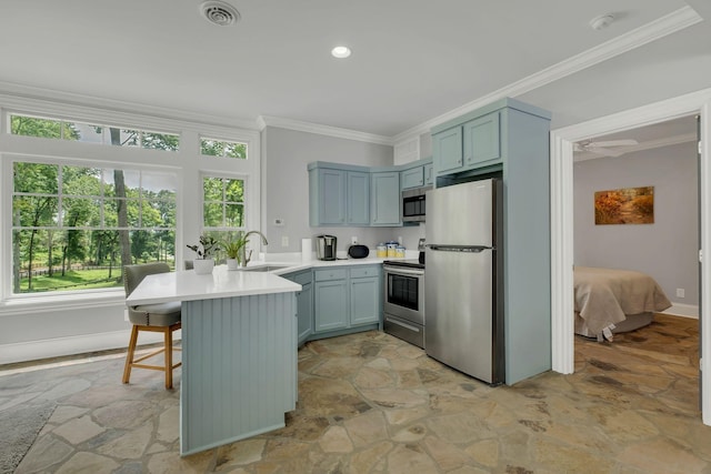3120 Boxley View Ln, Franklin, TN 37064 - kitchen featuring appliances with stainless steel finishes, a peninsula, light stone finish flooring, ornamental molding, and light countertops