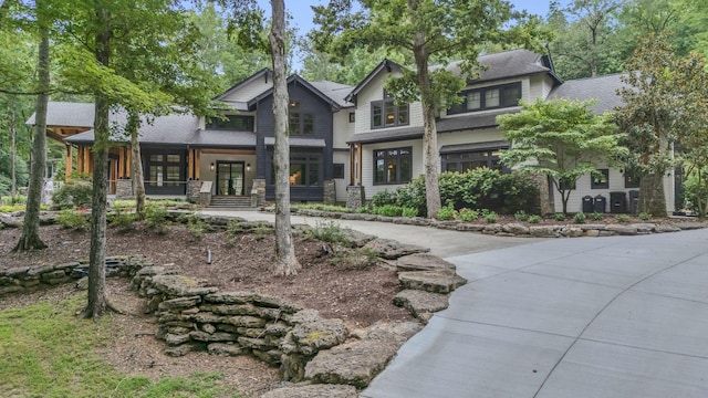 3120 Boxley View Ln, Franklin, TN 37064 - view of front of home featuring a porch, driveway, a shingled roof, and stone siding